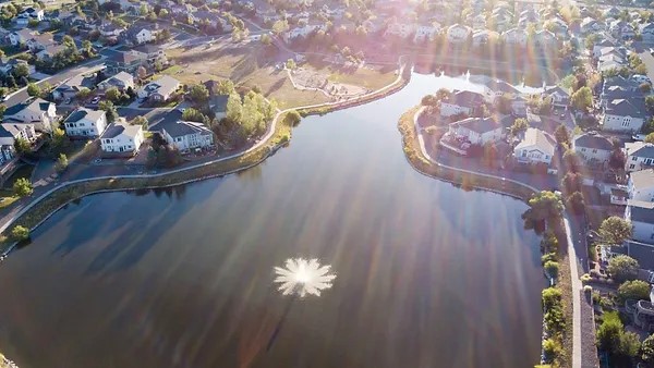 Aerial photo of homes and pond